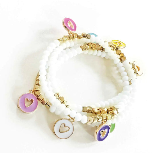 Stack of 4 hand-beaded Lover Bracelets with colorful enamel heart charms on gold accent beads.